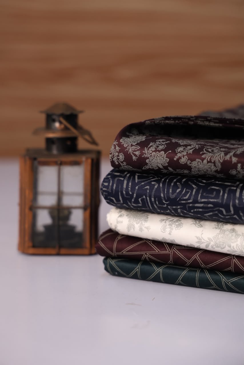 Folded fabrics beside a lantern